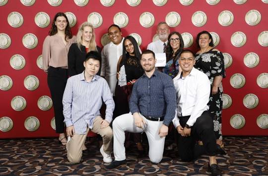 A group of people posing for a photo

Description automatically generated