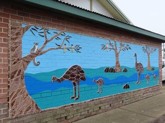 A mural on a brick wall

Description automatically generated