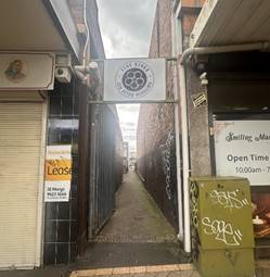 A narrow alleyway with signs

AI-generated content may be incorrect.